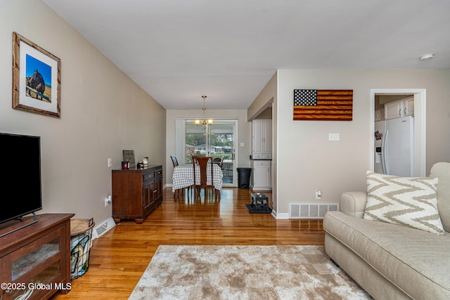 47 Comely Ln, Colonie, NY 12110 - living room with light wood finished floors and a chandelier