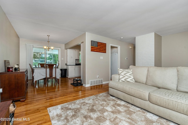 47 Comely Ln, Colonie, NY 12110 - living area with light wood-type flooring and a chandelier