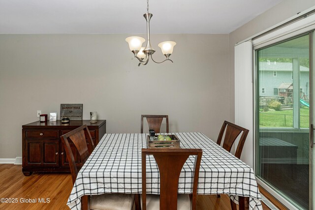 47 Comely Ln, Colonie, NY 12110 - dining area featuring a chandelier, healthy amount of natural light, and wood finished floors