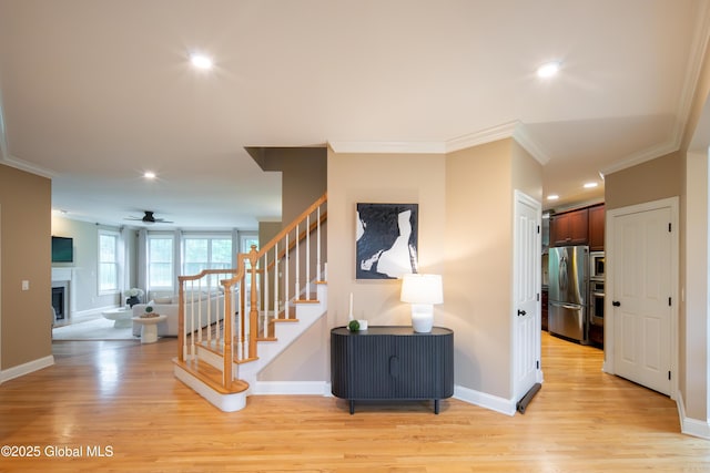 1 Arbor Dr, Guilderland, NY 12159 - stairway with crown molding, wood finished floors, ceiling fan, recessed lighting, and a fireplace