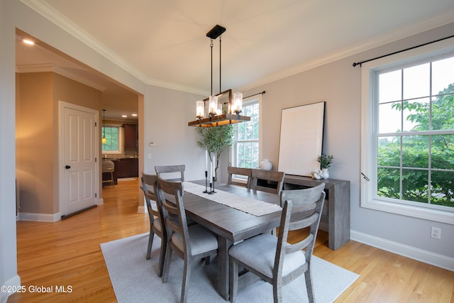 1 Arbor Dr, Guilderland, NY 12159 - dining area featuring plenty of natural light, light wood-style flooring, a chandelier, and crown molding