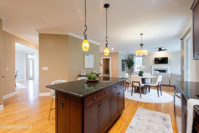 1 Arbor Dr, Guilderland, NY 12159 - kitchen featuring a breakfast bar area, a ceiling fan, light wood finished floors, crown molding, and hanging light fixtures