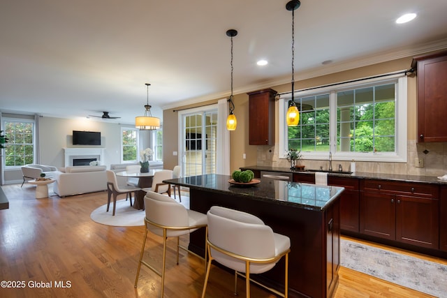1 Arbor Dr, Guilderland, NY 12159 - kitchen featuring open floor plan, a fireplace, decorative backsplash, a kitchen island, and stainless steel dishwasher