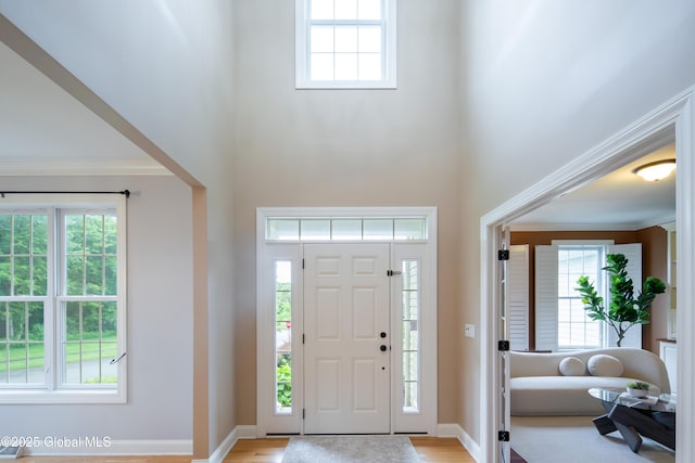 1 Arbor Dr, Guilderland, NY 12159 - entrance foyer featuring a towering ceiling, plenty of natural light, light wood-type flooring, and ornamental molding