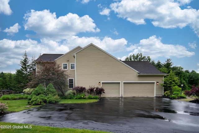 1 Arbor Dr, Guilderland, NY 12159 - view of side of property with asphalt driveway and a garage