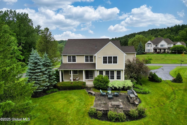 1 Arbor Dr, Guilderland, NY 12159 - view of front of property featuring a front yard, a patio area, a porch, and roof with shingles