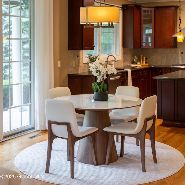 1 Arbor Dr, Guilderland, NY 12159 - kitchen with decorative backsplash, glass insert cabinets, a center island, and dark countertops