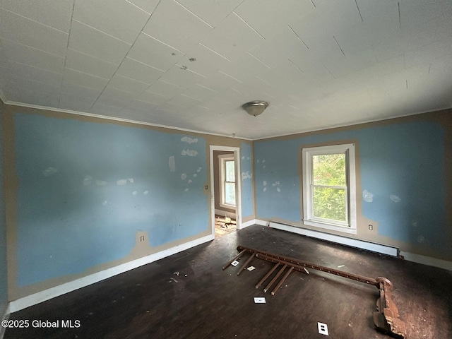 4 Factory St, Granville, NY 12832 - unfurnished room with a baseboard heating unit, wood finished floors, and crown molding