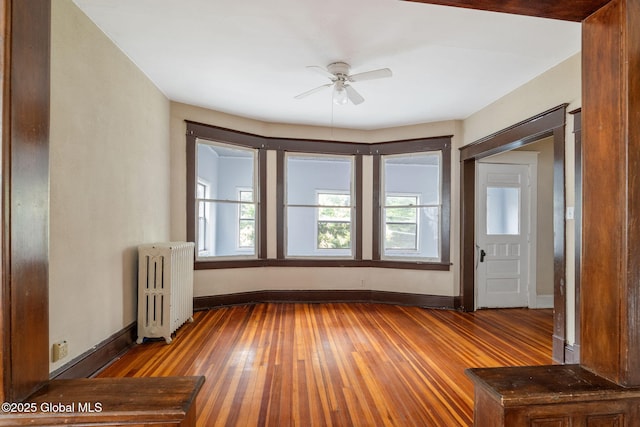 13 Barclay St, Albany, NY 12209 - empty room featuring radiator, hardwood / wood-style flooring, and ceiling fan