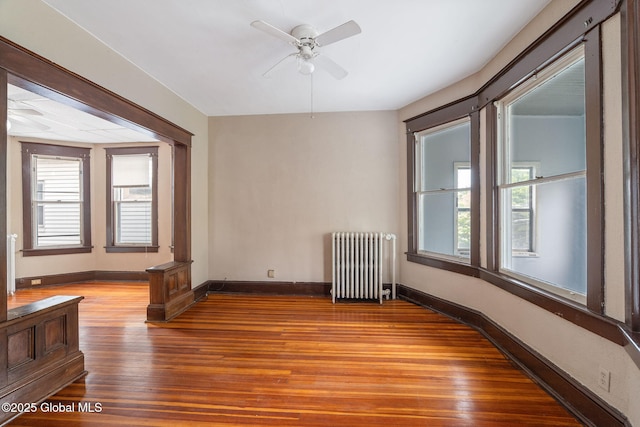 13 Barclay St, Albany, NY 12209 - empty room featuring radiator, wood finished floors, plenty of natural light, and a ceiling fan