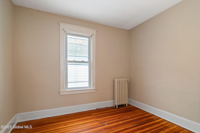 13 Barclay St, Albany, NY 12209 - spare room with radiator heating unit, healthy amount of natural light, and wood finished floors