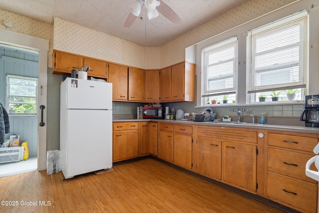 13 Barclay St, Albany, NY 12209 - kitchen with freestanding refrigerator, wallpapered walls, light wood finished floors, light countertops, and healthy amount of natural light