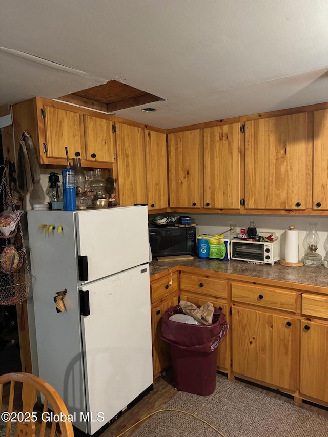 70 Cp A Way, Hartford, NY 12832 - kitchen featuring freestanding refrigerator, black microwave, brown cabinets, and dark countertops