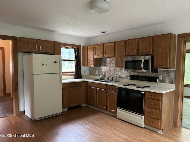 11 Ridgecrest Way, Hampton, NY 12887 - kitchen with white appliances, light wood-type flooring, light countertops, tasteful backsplash, and a textured ceiling