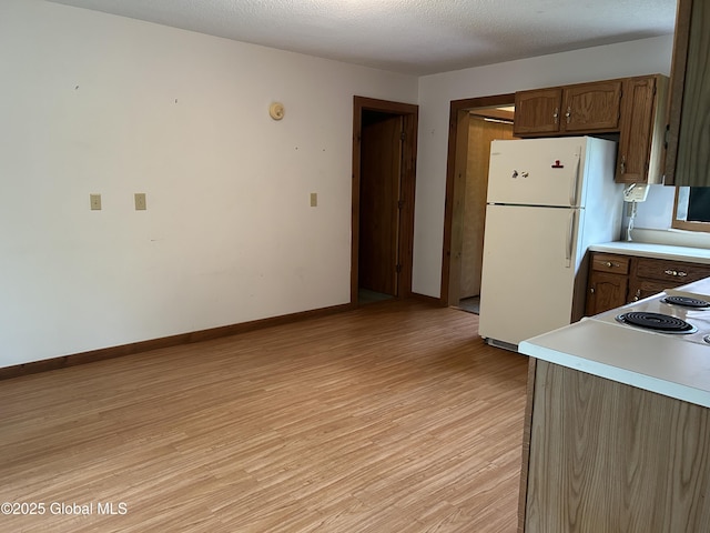 11 Ridgecrest Way, Hampton, NY 12887 - kitchen with freestanding refrigerator, light wood-style floors, and light countertops