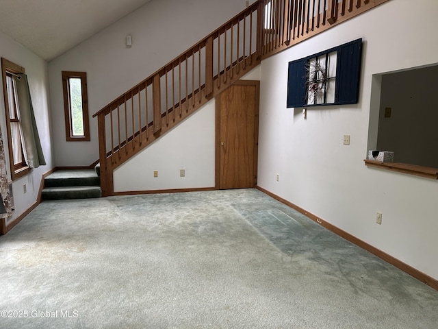 11 Ridgecrest Way, Hampton, NY 12887 - unfurnished living room featuring carpet flooring, stairway, and high vaulted ceiling