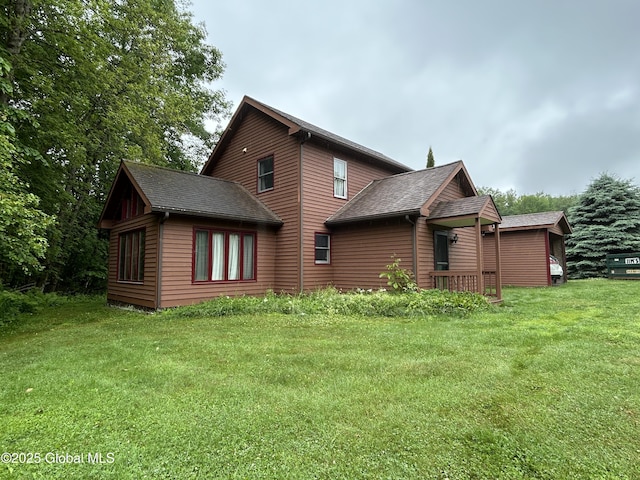 11 Ridgecrest Way, Hampton, NY 12887 - back of house featuring a lawn and roof with shingles