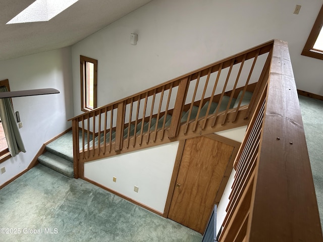 11 Ridgecrest Way, Hampton, NY 12887 - stairway featuring carpet, lofted ceiling, and a skylight