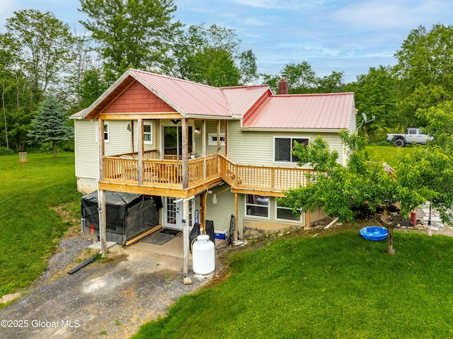 2560 Creek Rd, Esperance, NY 12066 - back of house with a metal roof, a lawn, a wooden deck, and dirt driveway