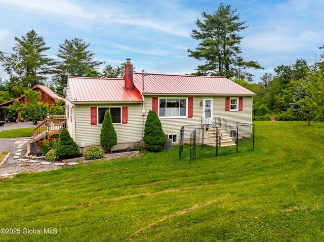 2560 Creek Rd, Esperance, NY 12066 - rear view of house with a chimney, a metal roof, and a yard