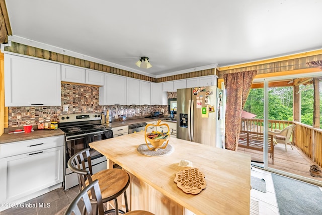 2560 Creek Rd, Esperance, NY 12066 - kitchen featuring stainless steel appliances, white cabinets, backsplash, wooden counters, and wooden walls