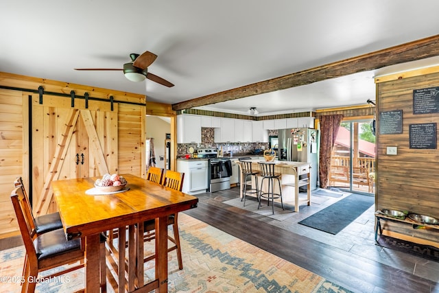 2560 Creek Rd, Esperance, NY 12066 - dining room with a ceiling fan, a barn door, wood finished floors, and wooden walls