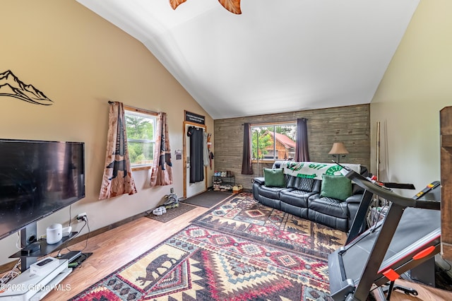 2560 Creek Rd, Esperance, NY 12066 - living room featuring plenty of natural light, wood walls, wood finished floors, high vaulted ceiling, and ceiling fan