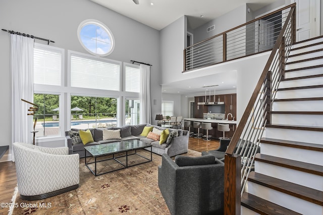 23 Steeple View Dr, Colonie, NY 12211 - living area with a towering ceiling, plenty of natural light, stairs, and wood finished floors