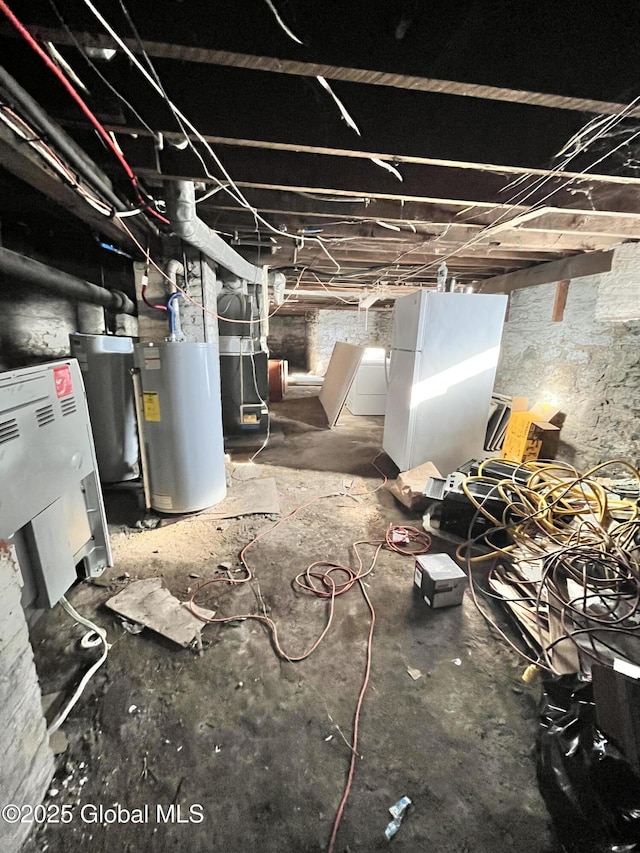 327 E Main St, Amsterdam, NY 12010 - unfinished basement with water heater and freestanding refrigerator