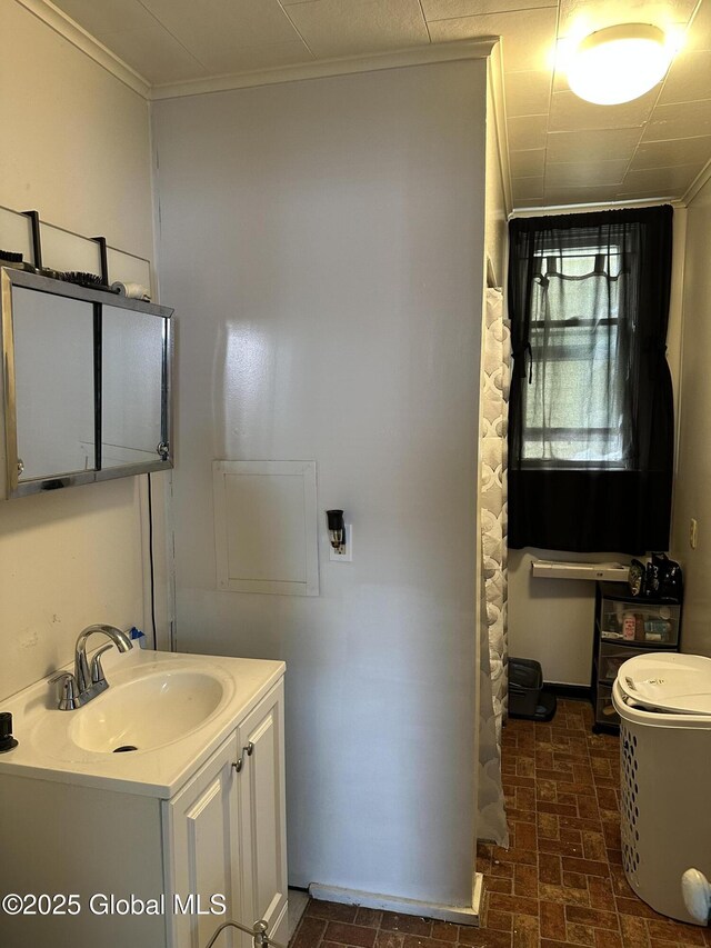 327 E Main St, Amsterdam, NY 12010 - bathroom with vanity, ornamental molding, and brick patterned floors