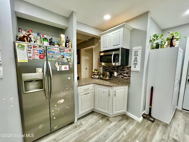 421 Michigan Ave, Schenectady, NY 12303 - kitchen featuring appliances with stainless steel finishes, light wood-type flooring, white cabinets, decorative backsplash, and light stone countertops