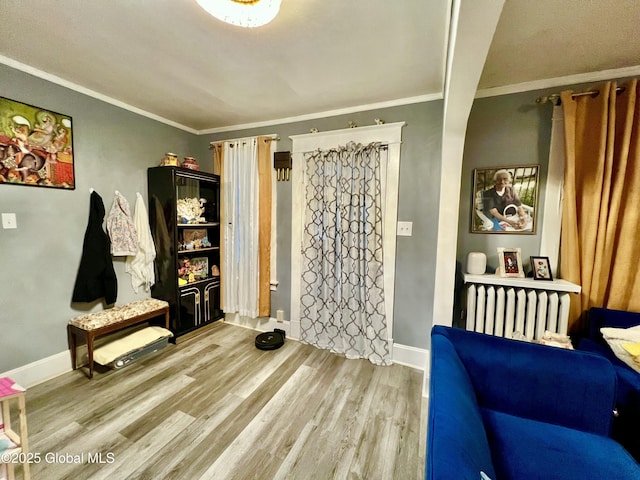 421 Michigan Ave, Schenectady, NY 12303 - foyer with radiator, wood finished floors, and crown molding