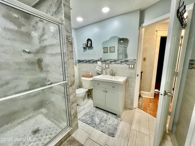 421 Michigan Ave, Schenectady, NY 12303 - full bathroom with vanity, a stall shower, wood finish floors, tile walls, and recessed lighting