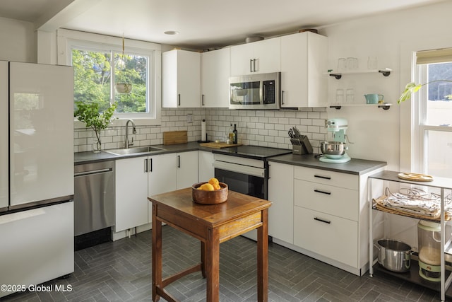 12 Mill St, Chatham, NY 12037 - kitchen with stainless steel appliances, decorative backsplash, and white cabinets