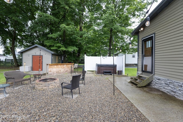 74 Feeder St, Hudson Falls, NY 12839 - view of patio / terrace featuring entry steps, a fire pit, a hot tub, and a storage unit