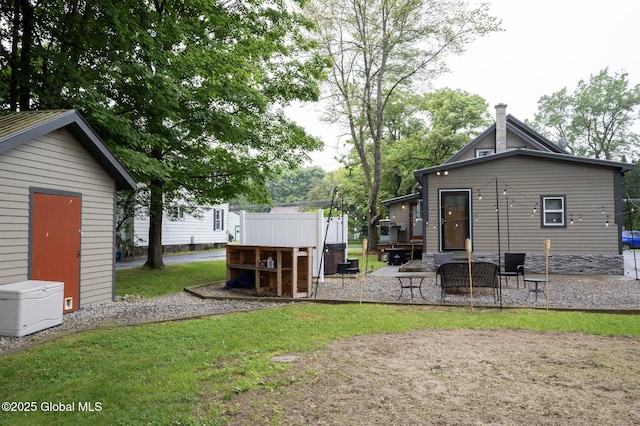74 Feeder St, Hudson Falls, NY 12839 - rear view of house featuring a patio area, a shed, and a lawn