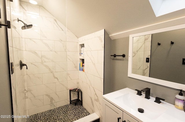 74 Feeder St, Hudson Falls, NY 12839 - bathroom with a tile shower, vanity, and lofted ceiling