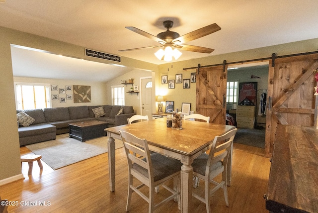 74 Feeder St, Hudson Falls, NY 12839 - dining space with a barn door, wood finished floors, ceiling fan, and lofted ceiling