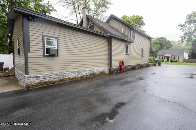 74 Feeder St, Hudson Falls, NY 12839 - view of home's exterior featuring a chimney and driveway