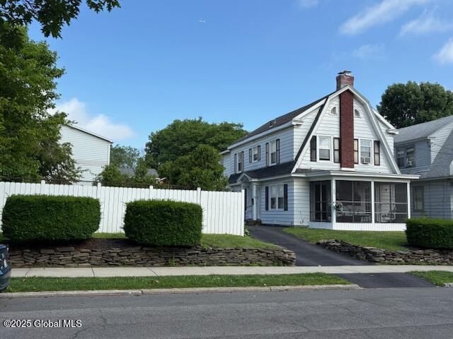 16 Edgewood Ave, Albany, NY 12203 - view of side of property with a sunroom, a chimney, and a gambrel roof