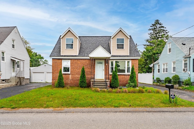 107 Frederick Ave, Colonie, NY 12205 - new england style home with brick siding, entry steps, an outbuilding, a shingled roof, and a detached garage