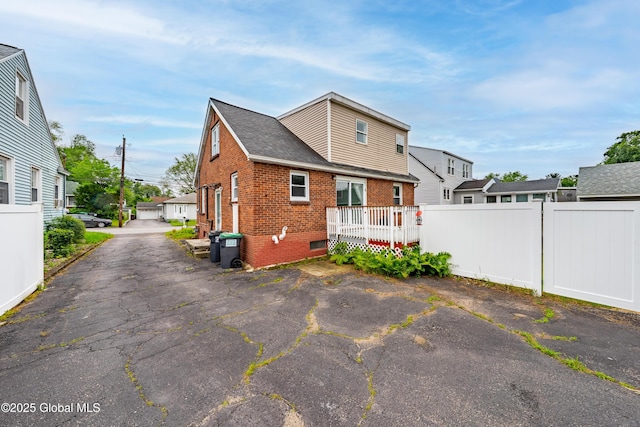 107 Frederick Ave, Colonie, NY 12205 - back of property featuring brick siding, a residential view, and a wooden deck