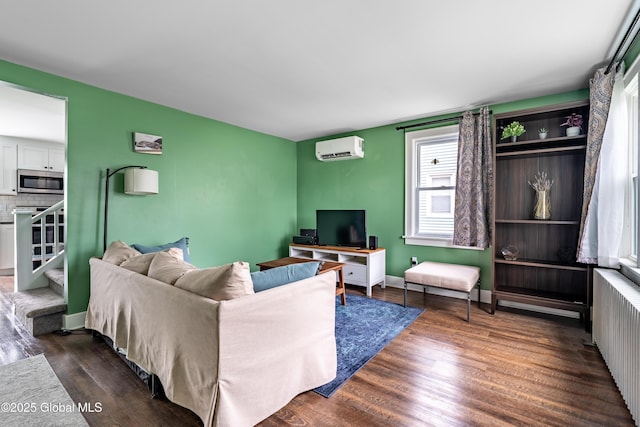 107 Frederick Ave, Colonie, NY 12205 - living area with an AC wall unit, radiator heating unit, and dark wood finished floors