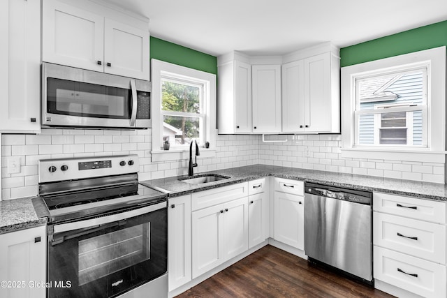 107 Frederick Ave, Colonie, NY 12205 - kitchen with appliances with stainless steel finishes, light stone counters, white cabinetry, and dark wood-type flooring