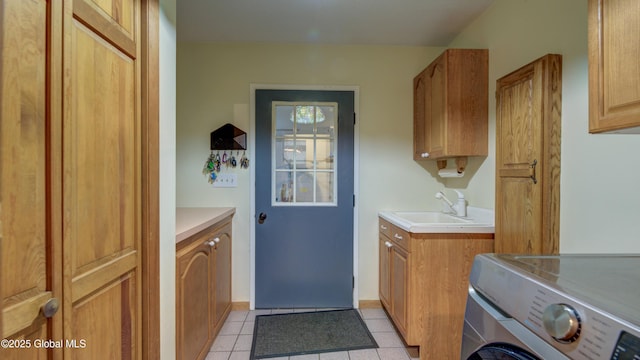 324 Elsmere Ave, Bethlehem, NY 12054 - laundry room featuring washer / dryer, cabinet space, and light tile patterned flooring