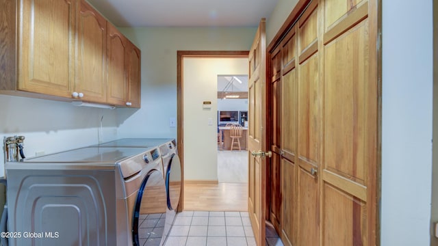 324 Elsmere Ave, Bethlehem, NY 12054 - washroom featuring cabinet space, washing machine and dryer, and light tile patterned floors