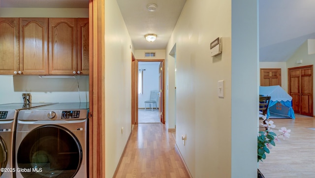 324 Elsmere Ave, Bethlehem, NY 12054 - laundry area featuring light wood-style floors, washer and dryer, and cabinet space