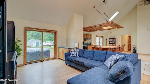 324 Elsmere Ave, Bethlehem, NY 12054 - living room featuring high vaulted ceiling, a skylight, and light wood-style flooring