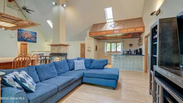 324 Elsmere Ave, Bethlehem, NY 12054 - living room with high vaulted ceiling, light wood finished floors, and a skylight