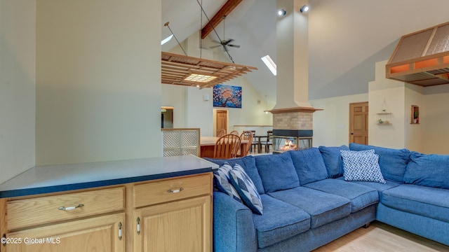 324 Elsmere Ave, Bethlehem, NY 12054 - living area with a skylight, high vaulted ceiling, beam ceiling, a ceiling fan, and light wood finished floors